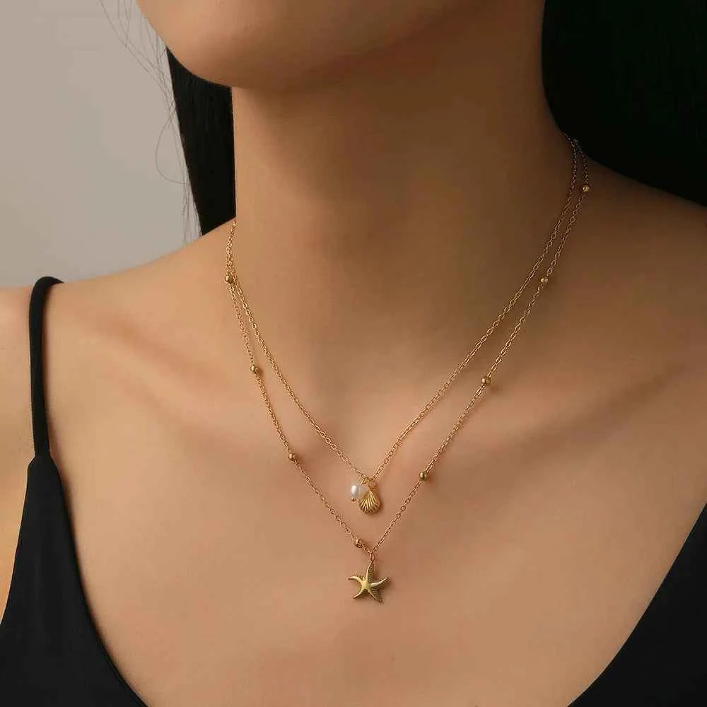Embrace Coastal Elegance with Our Gold Stacking Necklace Featuring Starfish & Shell Pendants
